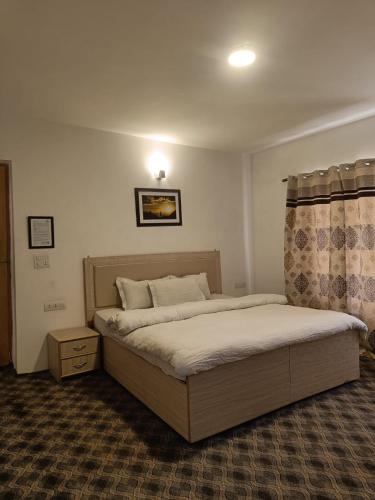 a bedroom with two beds in a room at yangphel house in Leh
