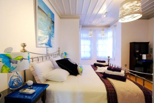 a room with a bed with pillows on it at Limnos Experience in Mirina