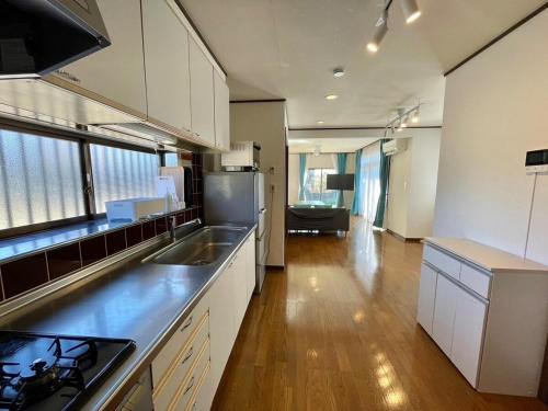 a kitchen with a sink and a counter top at Pets OK! Close to the sea! Starlit House with a dog run AC8 in Hasunuma