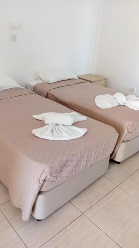 two beds sitting next to each other in a room at Napa Charles Apts in Ayia Napa
