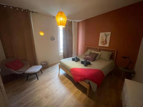 une chambre avec un lit avec une couverture rouge dans l'établissement Appartement au centre d'Avignon, à Avignon