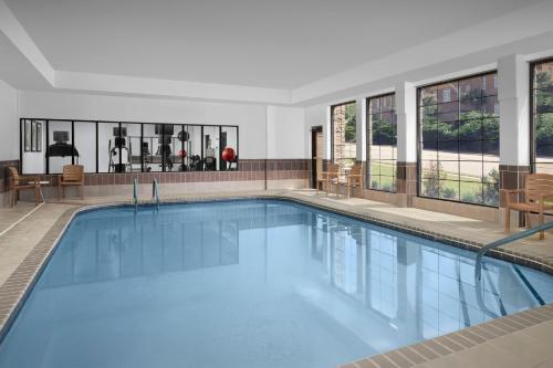 a large swimming pool with blue water in a building at Staybridge Suites North Charleston by IHG in Charleston