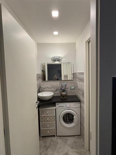 a bathroom with a washing machine and a sink at La Randa apartment in Vernazza