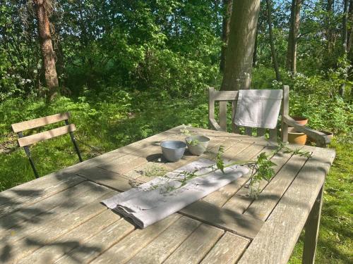 a wooden picnic table with plants on top of it at Brakilde B&B in Stege