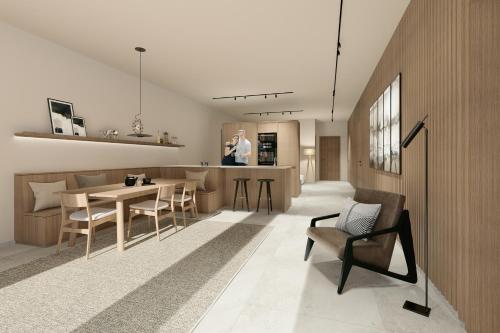 a kitchen and living room with a table and chairs at Appartement Chalet Saalbach in Saalbach Hinterglemm