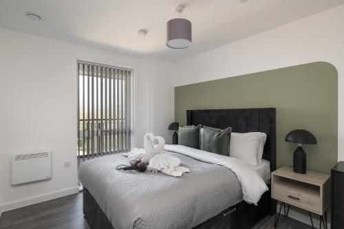 a bedroom with a bed with a stuffed animal on it at Lovely Home Near Canal, Park, & Central MK in Milton Keynes