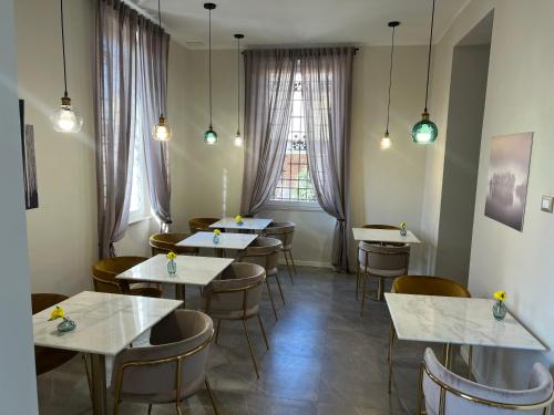a restaurant with tables and chairs and a window at Villa Demetrio Ars Hotel in Piacenza