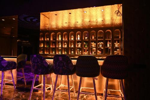 a group of stools in front of a wine rack at Kumar Resort By Turtle, Lonavala in Lonavala