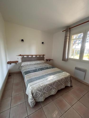 une chambre avec un lit avec une couette dessus dans l'établissement Gites les oliviers, à Montagnac