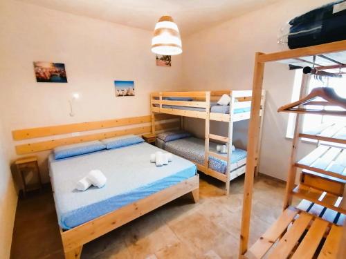a room with two bunk beds and a ladder at il borghetto in valle d'itria in Martina Franca