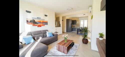 a living room with a couch and a table at Rosa dei venti- Sea View Apartment - AC in Lido di Camaiore