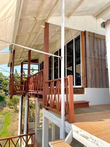 a porch of a house with a wooden deck at The Sun House อุทัยธานี in Ban Nam Tok