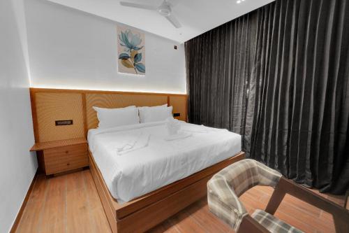 a small bedroom with a bed and a window at The Forest Glen by TIO Hotels in Yercaud