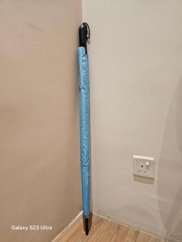 a blue umbrella hanging on the corner of a wall at NEW Bangsar Trade Centre KL Mid Valley LRT Bangsar in Kuala Lumpur