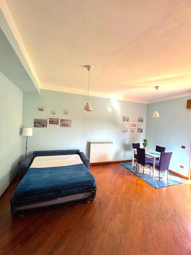 a bedroom with a bed and a table and chairs at MarePorto House in Fiumicino
