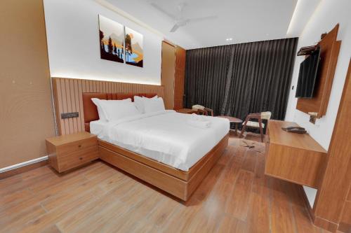 a hotel room with a bed and a desk and a desk at The Forest Glen by TIO Hotels in Yercaud