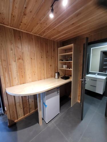 a kitchen with a desk and a sink in a room at Berry in Klatovy