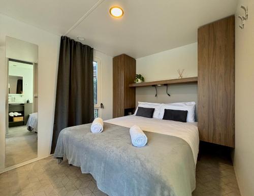 a bedroom with a large bed with two pillows on it at Seregnér Agricamping & Homes - Adults Only 18 in Monzambano