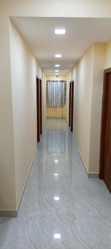 a hallway of a building with a long hallwayngth at VP Residency in Urapakkam