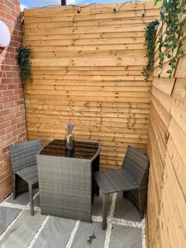 a patio with two chairs and a table and a fence at Modern with parking near Windsor Castle & Legoland in Windsor