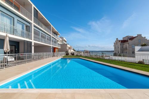 a swimming pool in front of a building at FozPenthouse in Foz do Arelho