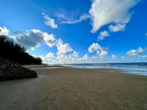 a beach with the ocean and clouds in the sky at Grandblue Condominium 307 Pool-SeaView MaePhim Rayong in Mae Pim