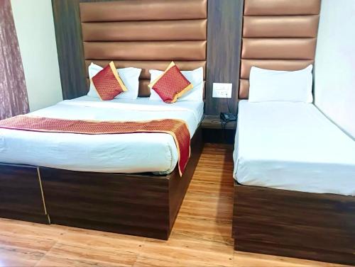 two beds in a hotel room with two at Hotel Novelty Inn - 2 min walk from Golden Temple in Amritsar