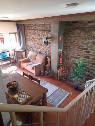 a living room with a couch and a table at Latada Suit's Serra da Estrela in Sameiro