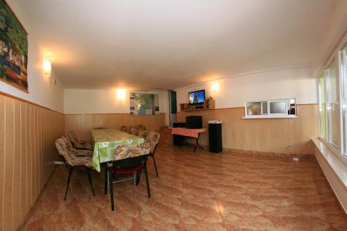 a room with a table and chairs and a room with a table at Casa Nelu Pescaru in Mahmudia