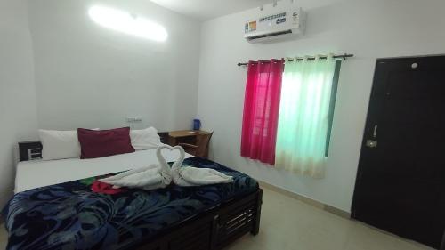 a bedroom with a bed with shoes on it at Fusion Nest Homestay Munnar in Anaviratty