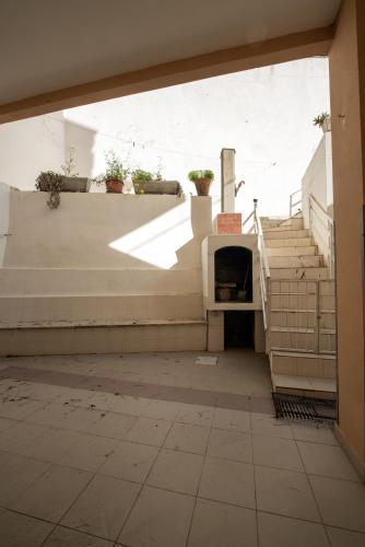 an entrance to a building with stairs and a stair case at Le conchiglie relax in spiaggia in Lido Conchiglie