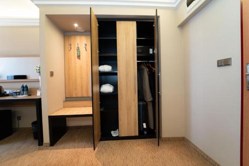 a walk in closet in a room at Hotel Festival in Opole