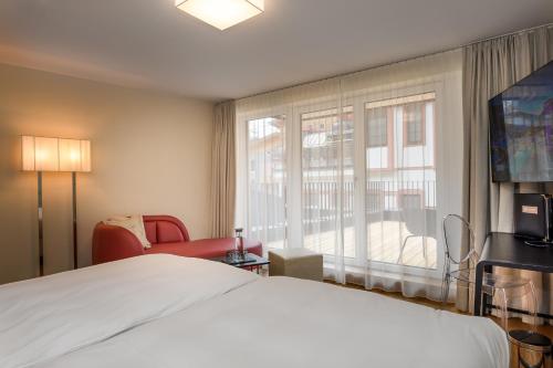 a hotel room with a bed and a window at Alpinresort ValSaa - Sport & Spa in Saalbach Hinterglemm