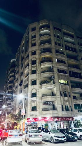 a large building with cars parked in front of it at Your Home Flat in Cairo in Cairo