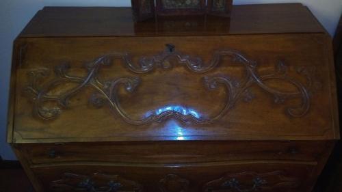 a wooden dresser with a clock on top of it at Comfortable house - garden and parking in Farra di Soligo