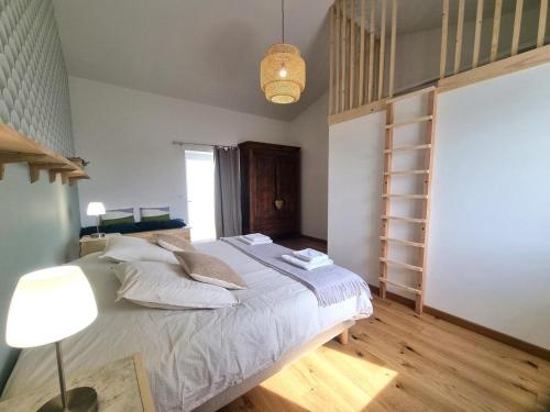 a bedroom with a bed with a lamp and a book shelf at La Ferme des Galoches in Villemontais
