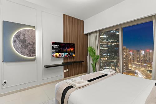 a bedroom with a large bed and a large window at Desert Key - Platinum Apartments in Gate Tower, Al Reem Island in Abu Dhabi