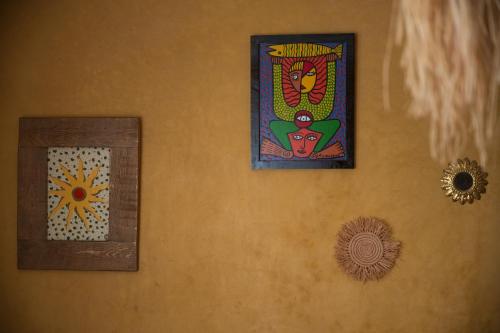 three pictures hanging on a wall in a room at The Mogador's Oasis in Akermoud