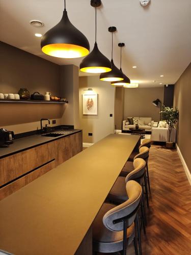 a large kitchen with a long table and chairs at The Basement in Saint Annes on the Sea
