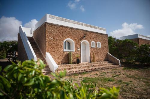 a brick building with stairs in front of it at The Mogador's Oasis in Akermoud