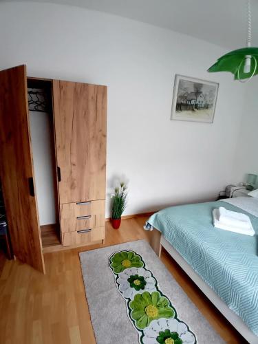 a bedroom with a bed and a rug on the floor at Apartman NADA in Krapina