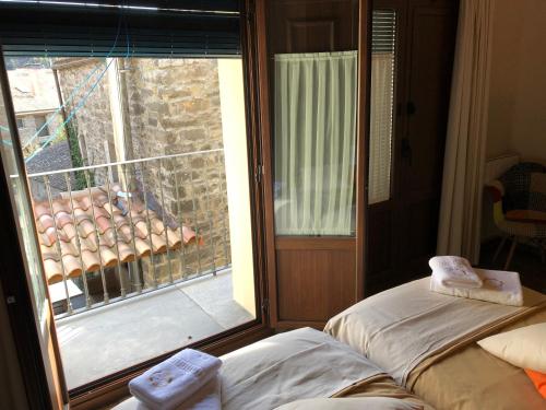 a room with a window with a view of a balcony at Casa FOR in Labuerda