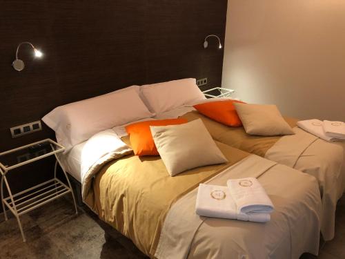 two beds in a room with towels on them at Casa FOR in Labuerda