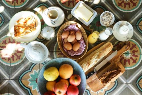 a table topped with bowls of eggs and bread at Le Presbytère de Bugarach in Bugarach
