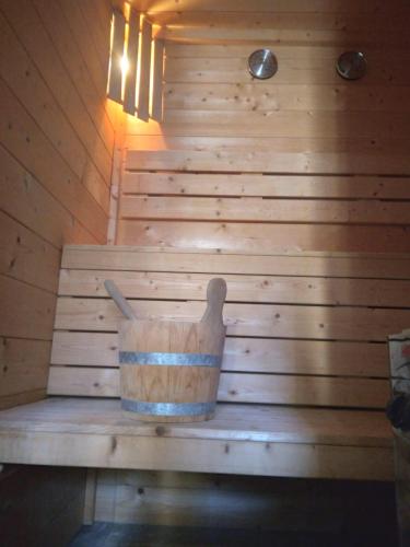 a wooden tub in a sauna with a wooden wall at Haus Lucky in Rosenau am Hengstpass