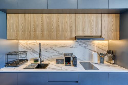 a kitchen with marble counter tops and wooden cabinets at Loyo Villas in Tegalalang