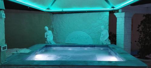 a large bath tub with statues in a room at Sea View Villa Paramonas in Paramonas
