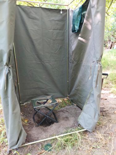 a tent with a table in the middle at Golentle Home Stay in Maun