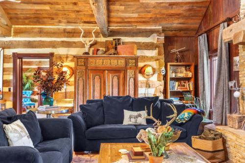 a living room with a blue couch and a table at Relics Reserve in Wimberley