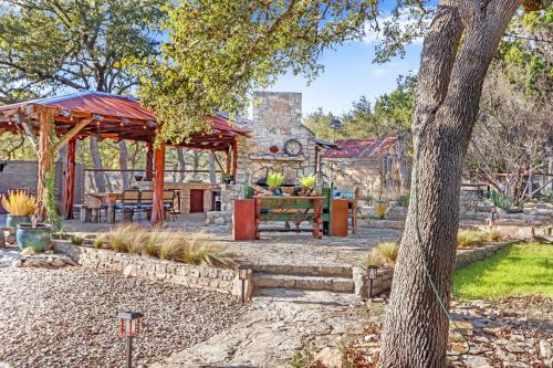 a garden with a picnic table and a pavilion at Relics Reserve in Wimberley